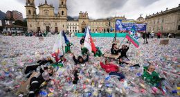 Colombian waste pickers inundate iconic Bogota square with plastic bottles to protest falling wages