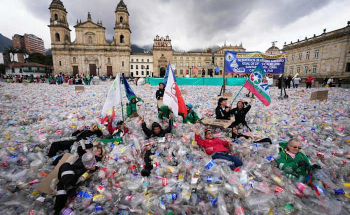 Colombian waste pickers inundate iconic Bogota square with plastic bottles to protest falling wages