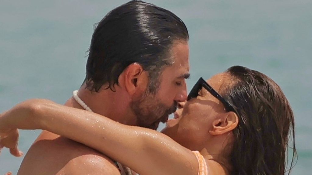 Eva Longoria rocks cheeky orange swimsuit as she packs on PDA with husband Jose Baston on beach in Spain