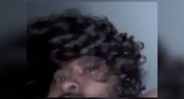 Blurry image of a man with curly hair