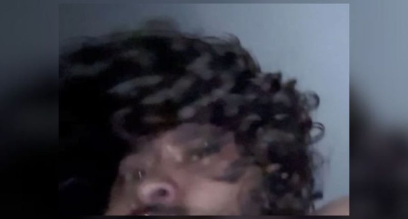 Blurry image of a man with curly hair