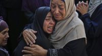 Relatives of Palestinians killed in Israeli strikes on the Gaza Strip mourn their deaths at Al-Shifa Hospital in Gaza City, Saturday, June 28, 2025. (AP Photo/Jehad Alshrafi)