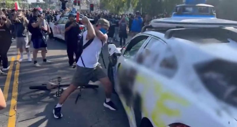 LA burns on camera: Most shocking videos of city riots show police cars pelted with rocks, van driven into crowd, a reporter getting SHOT and mindless destruction 