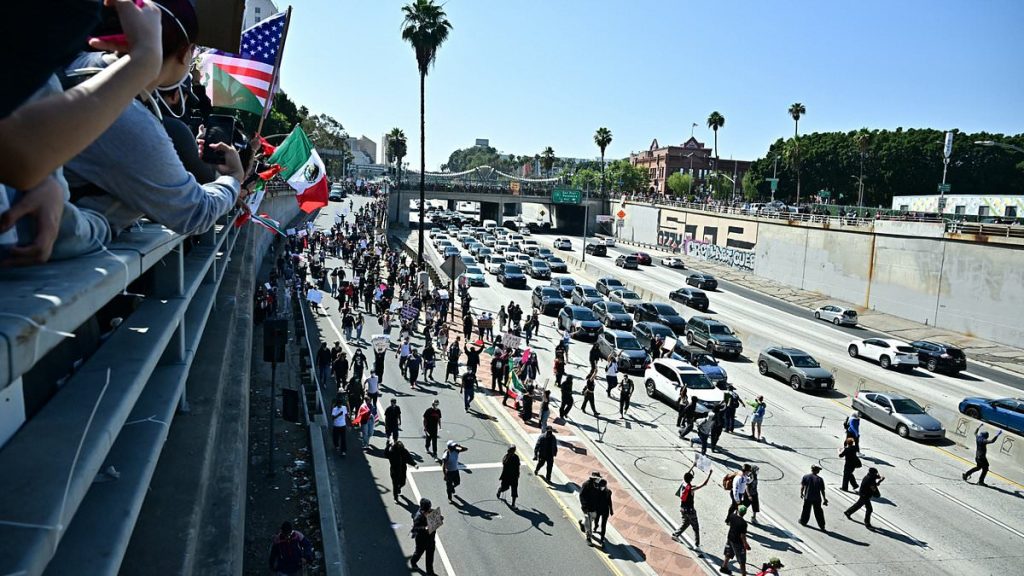 Los Angeles gripped by chaos as protesters storm major highway