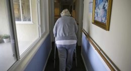 A woman uses a walker as she heads to her room at a senior care home in Calistoga, Calif., on Dec. 5, 2019. (AP Photo/Eric Risberg, File)