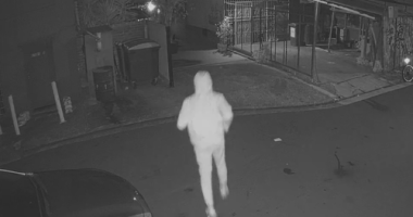 At the same location 24 hours earlier, a hooded figure is seen running in and out before the shop goes up in flames.