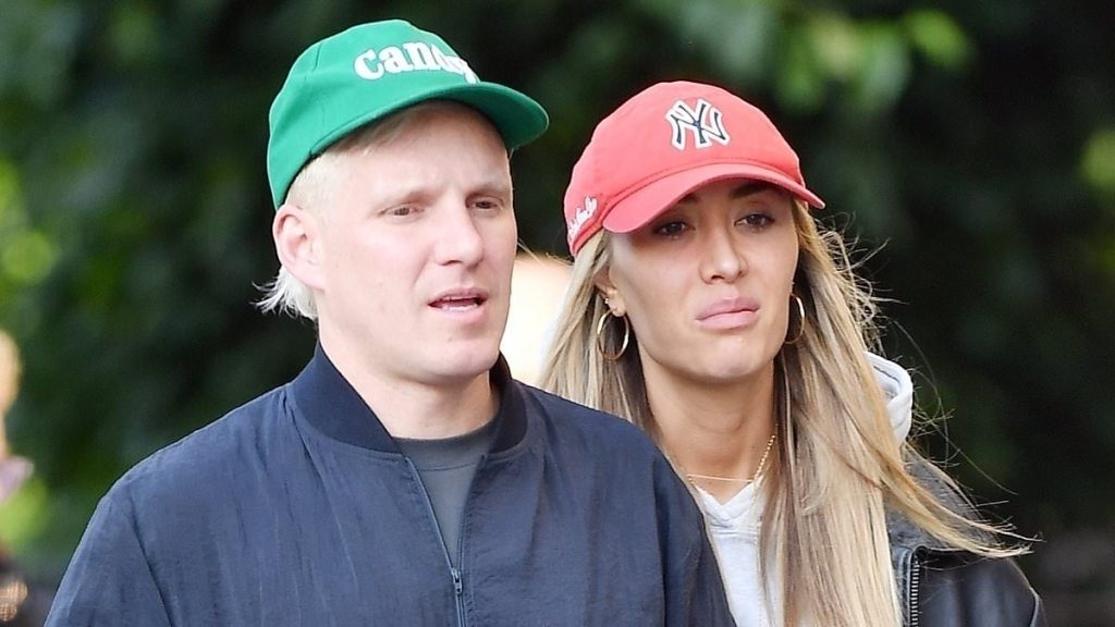 Pregnant Sophie Habboo links arms with husband Jamie Laing as they step out in London after he threatened to leave her over 'unbearable' hormones