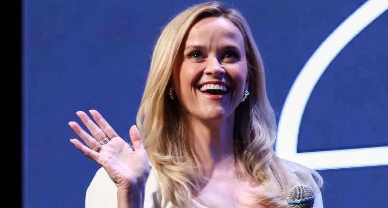 Reese Witherspoon puts on a leggy display in a chic white mini dress