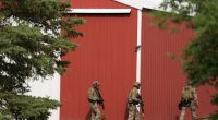 Members of law enforcement agencies search for shooting suspect, Vance Boelter, at a house Sunday, June 15, 2025, in Belle Plaine, Minn. (AP Photo/George Walker IV)