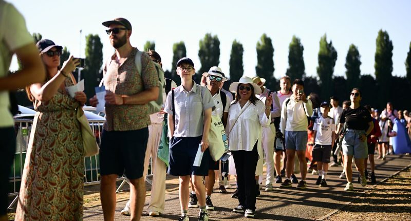 Tennis fans told NOT to travel to Wimbledon with queue 'at capacity' and crowds facing 'several hours to get in' in 34C on hottest opening day ever