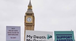 Banners are held by pro-assisted dying campaigners as they gather outside Parliament in London, May 15, 2025