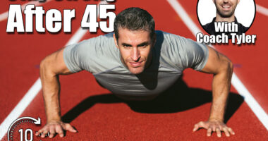 Mature fitness man in gray t-shirt looking and doing push-ups on the red running track. Copy space. Close up. Lifestyle and sports. 5 Classic Exercises Men Should Do Every Day to Stay Young After 45. Cover,