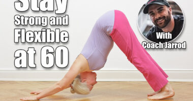 Senior woman with gray hair doing yoga exercise at home in front of a white wall, asana downward dog. 5 Daily Moves That Keep Your Body Strong and Flexible at 60 , cover