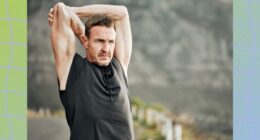 mature man stretching outdoors while on a run