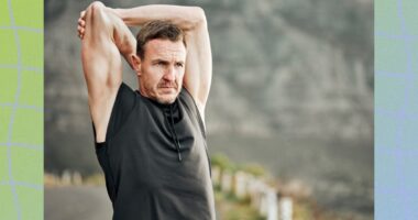 mature man stretching outdoors while on a run