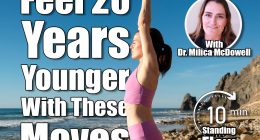 woman standing on rocks by the sea meditating and practicing yoga, arms above head, 5 Simple Standing Exercises That Make You Feel 20 Years Younger, Cover