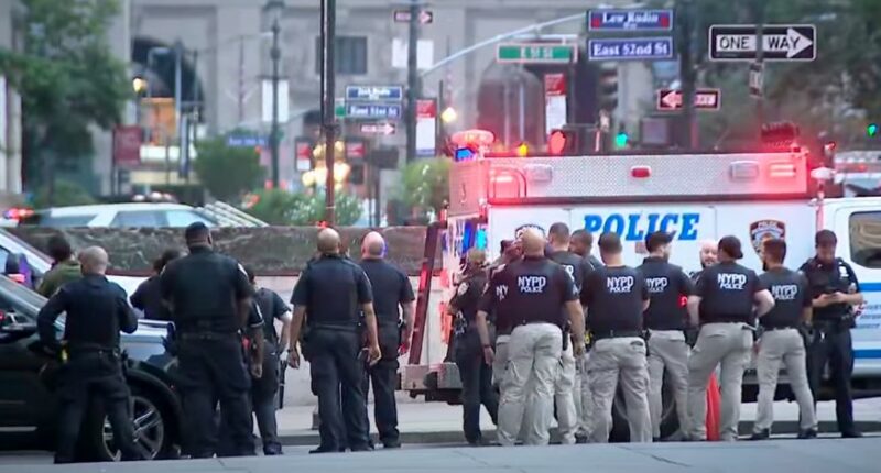 NYPD officers at a New York City shooting scene.