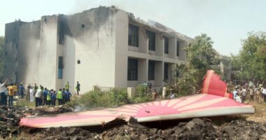 Debris from a plane crash near a building.