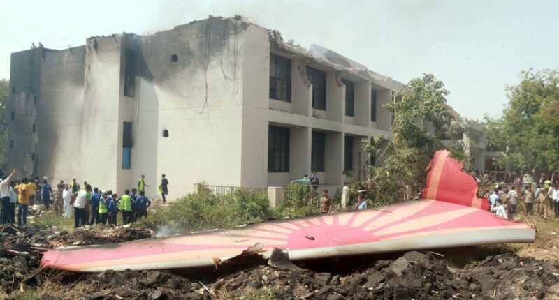 Debris from a plane crash near a building.