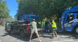 Residents loading garbage bags into a pickup truck during a garbage collection disruption.