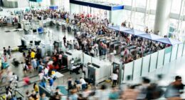A blurry photo of a crowded railroad station lobby.