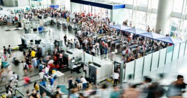 A blurry photo of a crowded railroad station lobby.