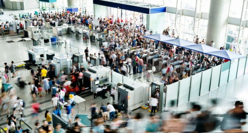 A blurry photo of a crowded railroad station lobby.