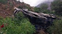 Wrecked bus on a hillside.