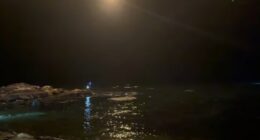 Nighttime search and rescue operation at sea.