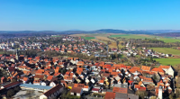 Aerial view of a town with red-tiled roofs.