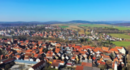 Aerial view of a town with red-tiled roofs.