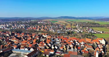 Aerial view of a town with red-tiled roofs.