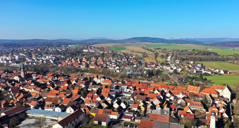 Aerial view of a town with red-tiled roofs.