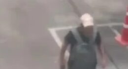 Suspect walking in a parking lot near Or Tor Kor Market in Bangkok, Thailand.