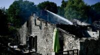 Firefighters work at the site of a French holiday cottage gite for disabled adults where a fire broke out leaving one person dead and four people still missing in Montmoreau, south-western France, on July 28, 2025. According to a gendarmerie source, 12 disabled people were inside, in addition to the couple who run the gite. The fire is thought to have been caused by a fault in the electrical installation, according to the same source. (Photo by Philippe LOPEZ / AFP) (Photo by PHILIPPE LOPEZ/AFP via Getty Images)