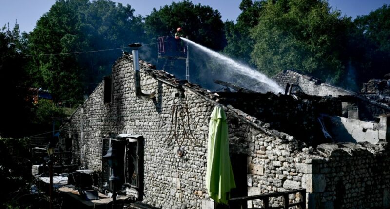 Firefighters work at the site of a French holiday cottage gite for disabled adults where a fire broke out leaving one person dead and four people still missing in Montmoreau, south-western France, on July 28, 2025. According to a gendarmerie source, 12 disabled people were inside, in addition to the couple who run the gite. The fire is thought to have been caused by a fault in the electrical installation, according to the same source. (Photo by Philippe LOPEZ / AFP) (Photo by PHILIPPE LOPEZ/AFP via Getty Images)