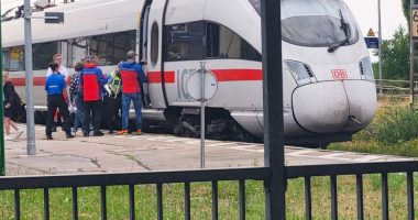 Passengers and first responders at an ICE train following an axe attack.