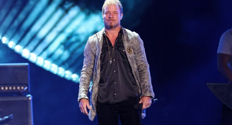 Brian Littrell of the Backstreet Boys performing onstage.