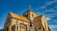 Normandy, France, August 31, 2019: Looking at the St-Nicolas church at the city of Barfleur. It is a French commune in the department of Manche in the Normandy region. it is classified as one of the Plus beaux villages de France - most beautiful villages in France.