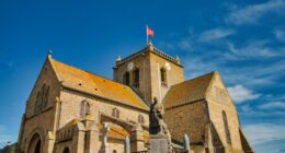 Normandy, France, August 31, 2019: Looking at the St-Nicolas church at the city of Barfleur. It is a French commune in the department of Manche in the Normandy region. it is classified as one of the Plus beaux villages de France - most beautiful villages in France.