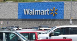 A Walmart store with a full parking lot.