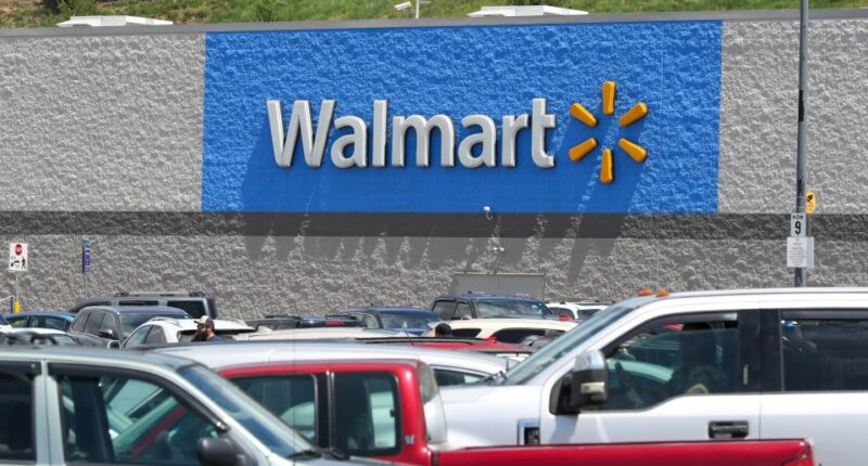 A Walmart store with a full parking lot.