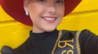 Portrait of Camila Trevisol, a rodeo queen, wearing a red cowboy hat and sash.