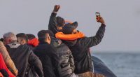 Migrants in a small boat taking a selfie while crossing the English Channel.