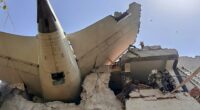 Debris of an Air India plane embedded in a building after a crash.