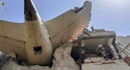 Debris of an Air India plane embedded in a building after a crash.