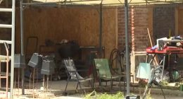 Exterior of a cluttered shed where two children lived.