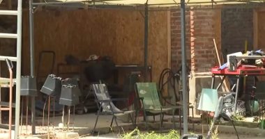 Exterior of a cluttered shed where two children lived.