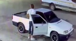 Screenshot of a video showing a person filling bottles with petrol, along with a van and a pickup truck.