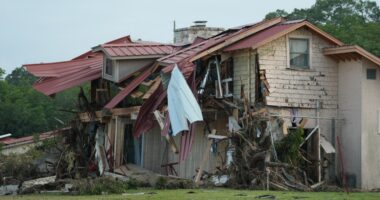 Flood-damaged building with its roof torn off.